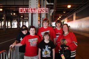 Optiva Signs celebrates the Blackhawks' Stanley Cup win by having fans pose with a portable, battery-powered “DA’ HAWKS” SpellBrite sign.